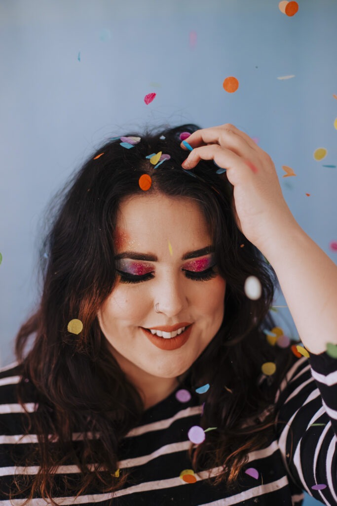 Self portrait photo of woman with rainbow makeup