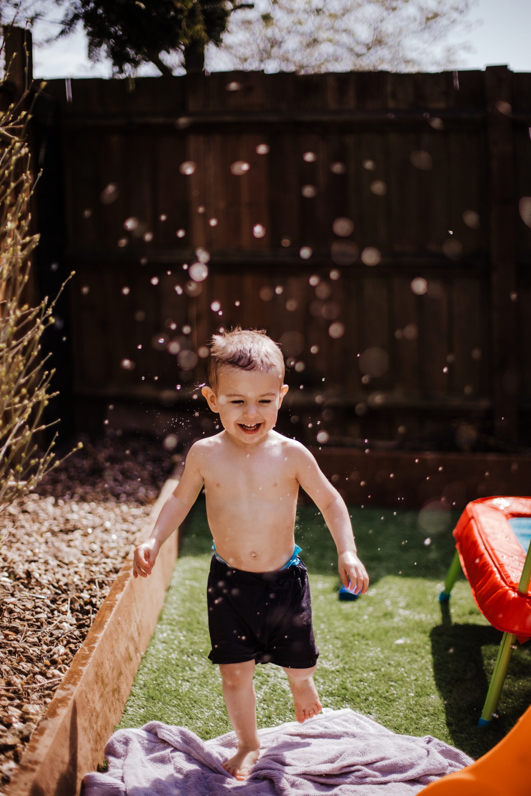 Picture of kid running through water sprinkles