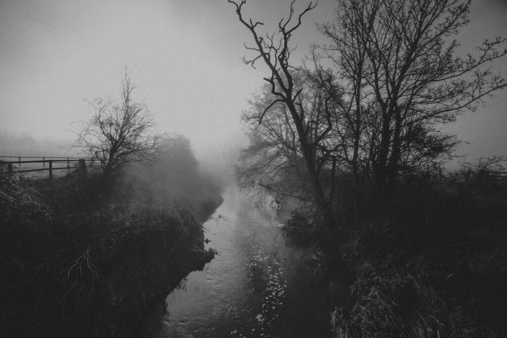 Black and white picture of a river in West Lydford on a foggy day - 10 Photography Tips That Aren't Boring