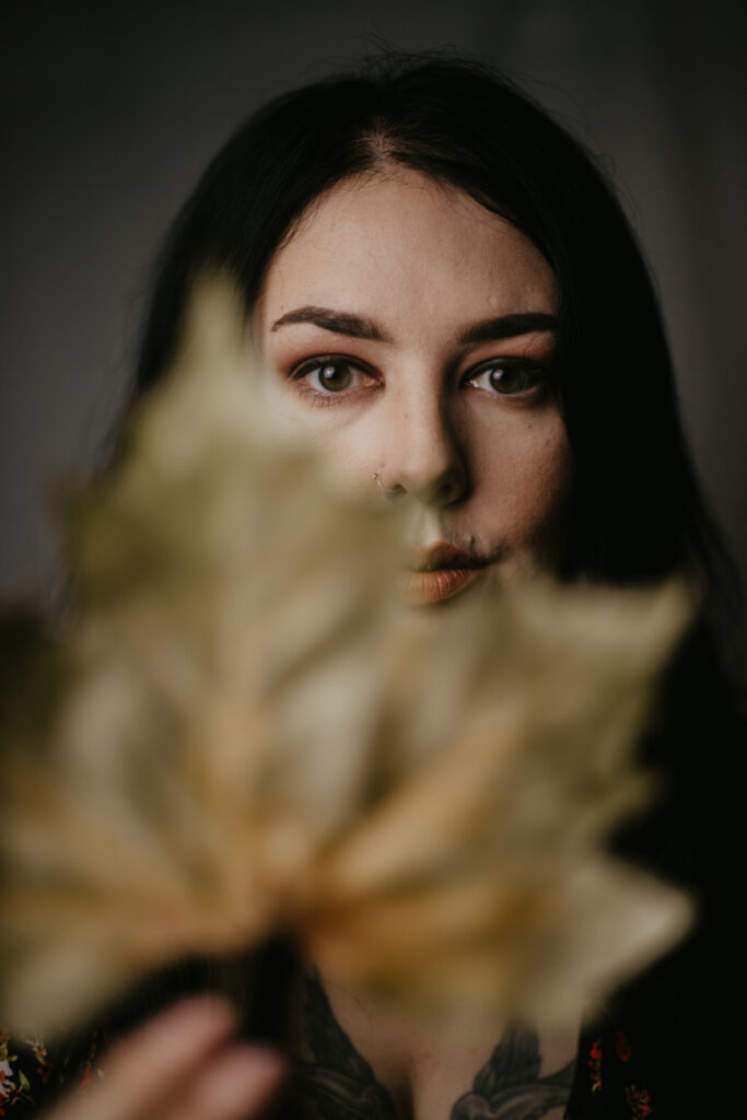 Photograph of leaf in front of face