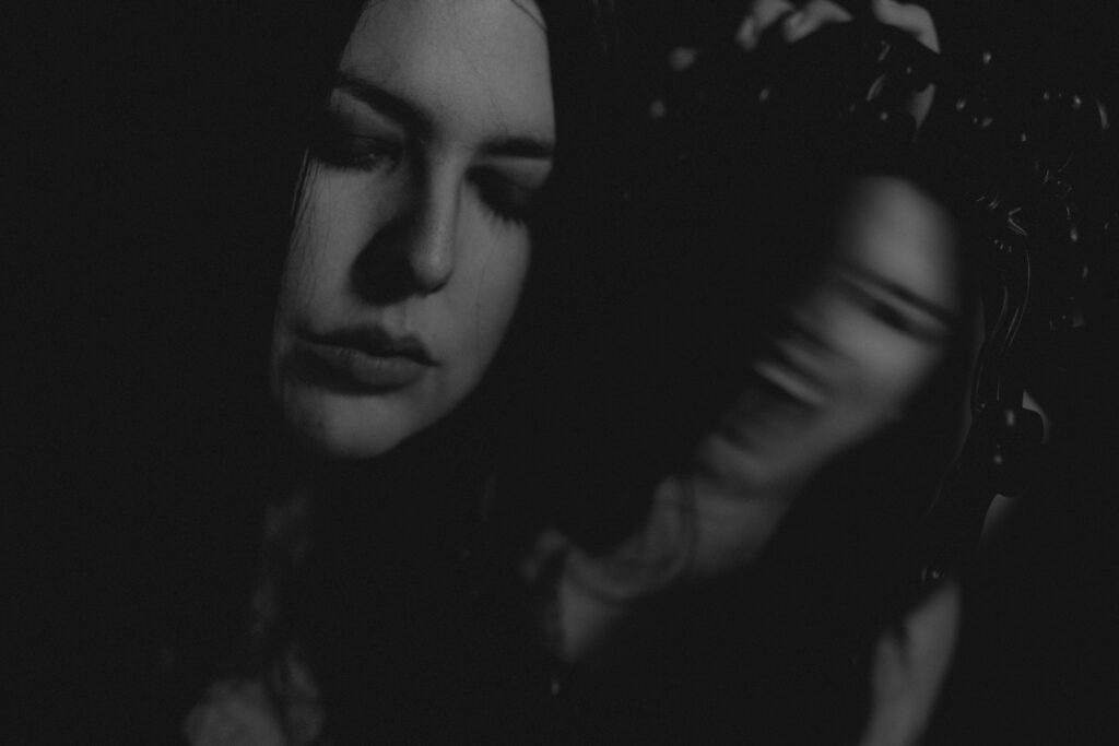 Dark and moody self portrait of creepy reflection in mirror.