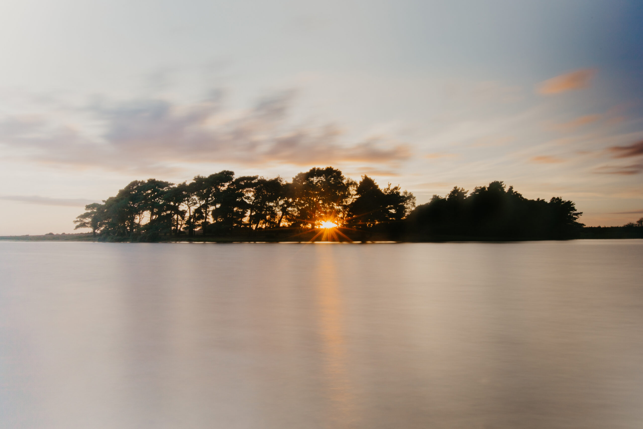 Long exposure water photography example: Hatchet Pond in New Forest at Sunset.