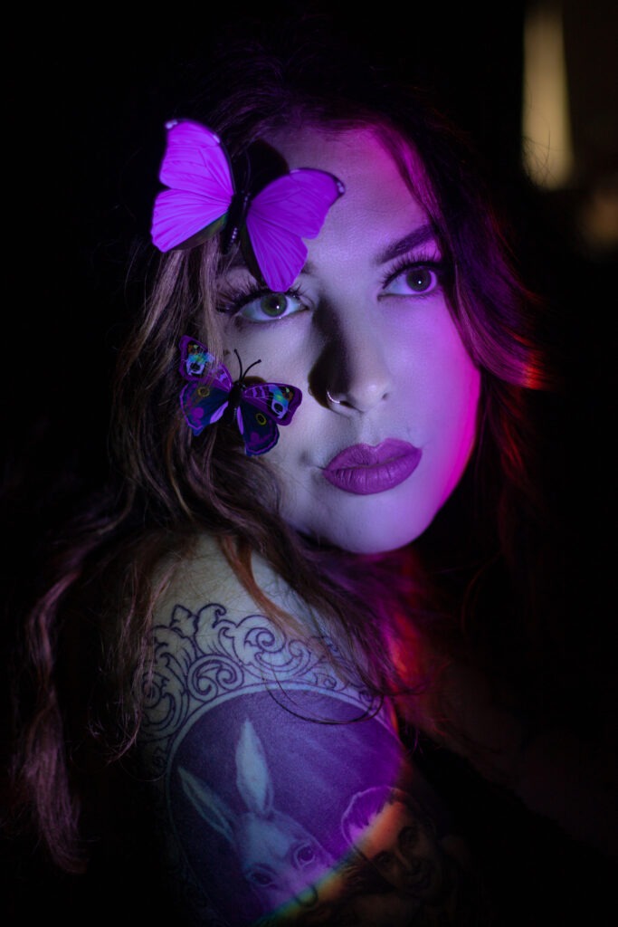 Self portrait with butterflies and purple sunset lamp