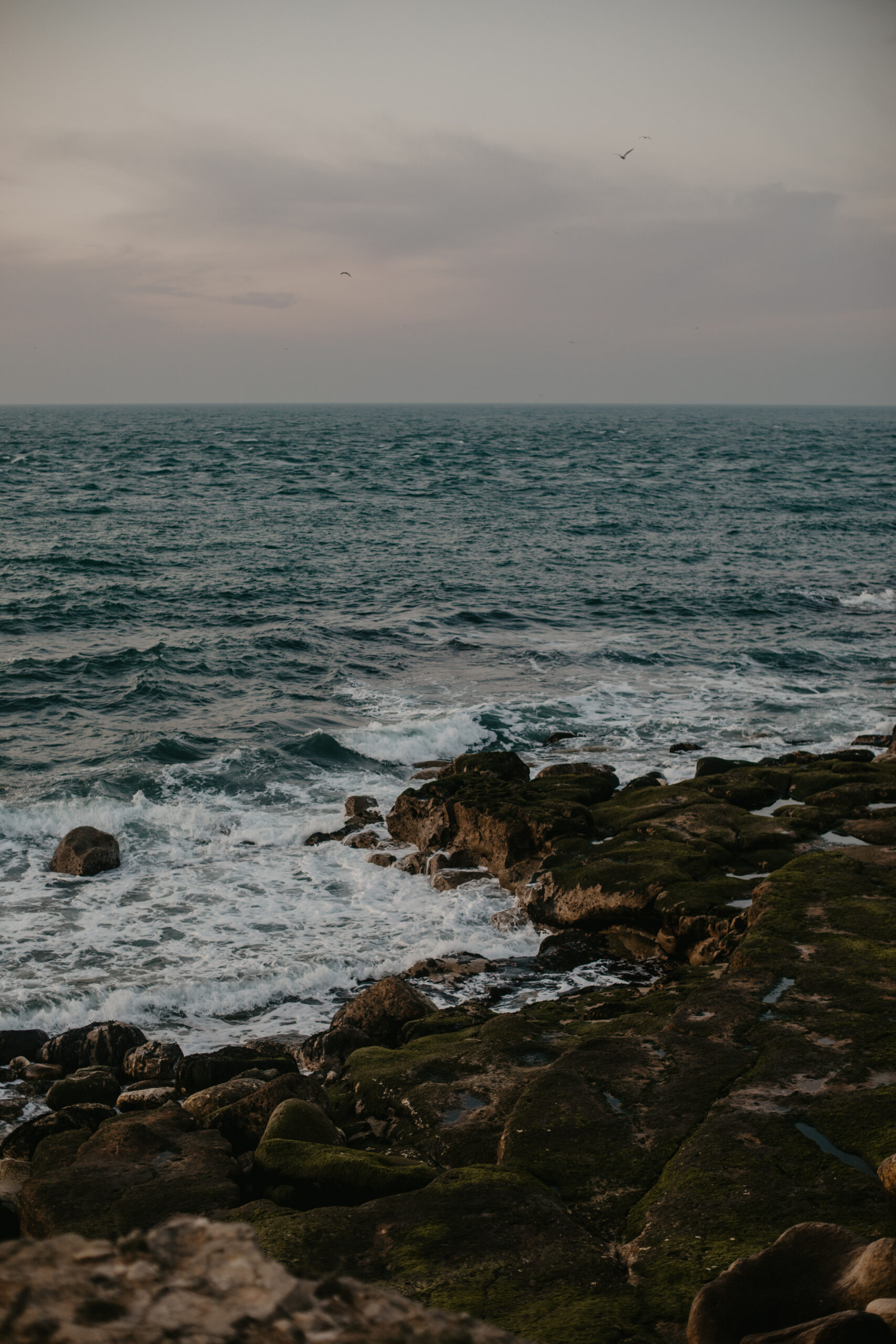 Waves crashing onto rocks at Portland Bill, Dorset at sunrise