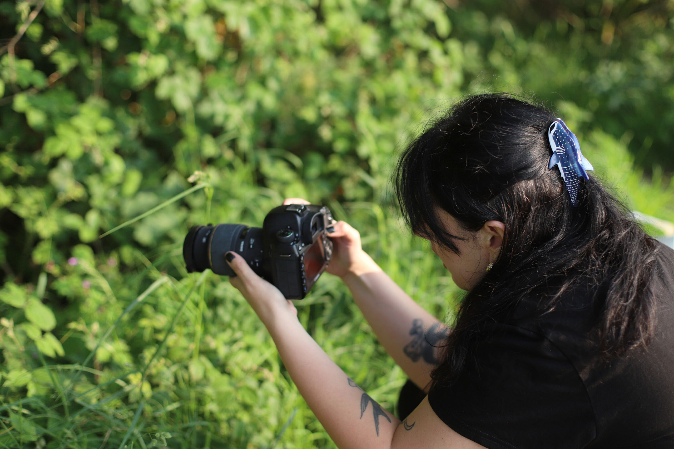 Photographer taking pictures outdoors with a sigma 105mm 2.8 macro lens - how to start photography on a budget