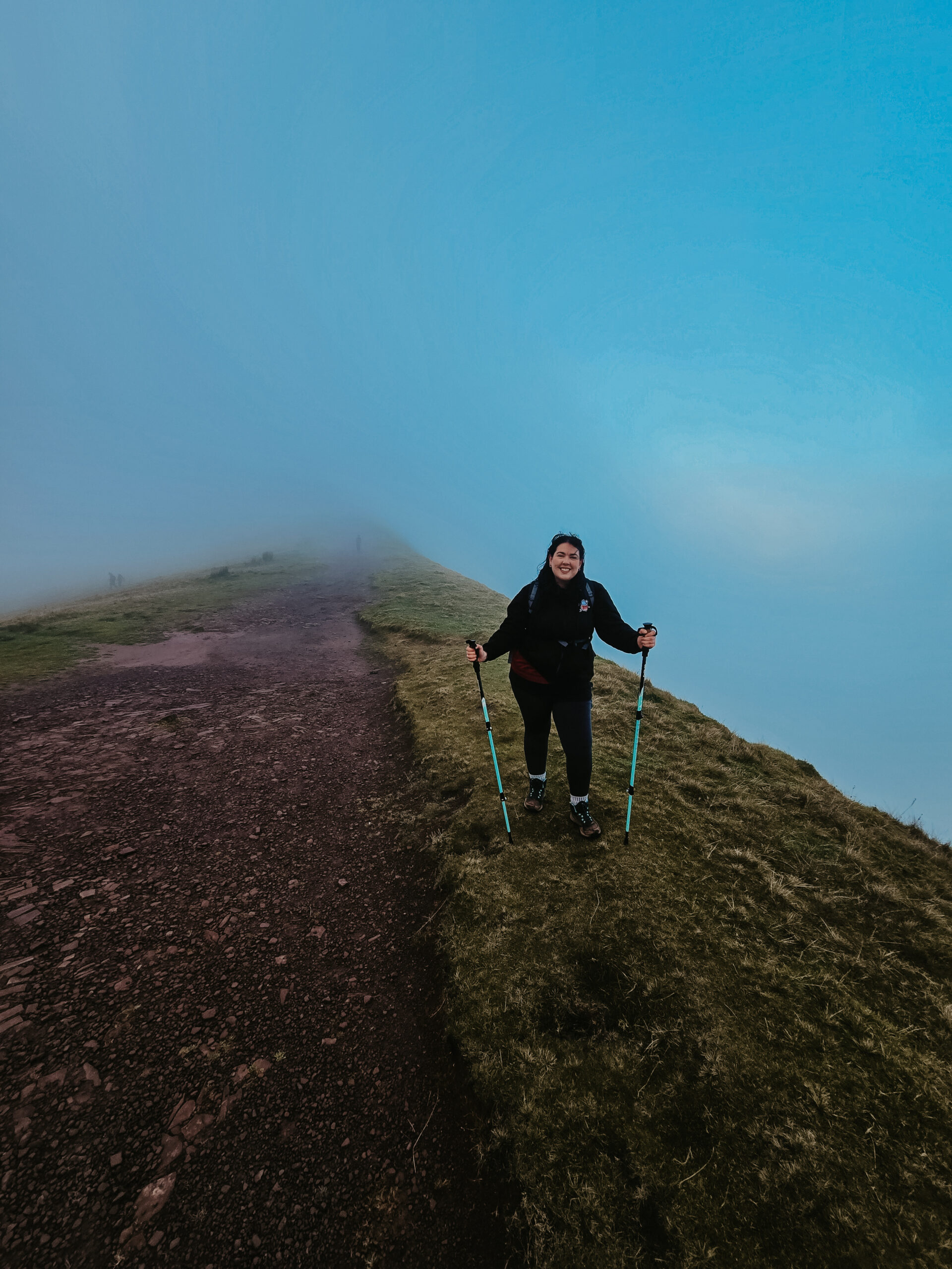 Hiker in the mist on top of Pen Y Fan