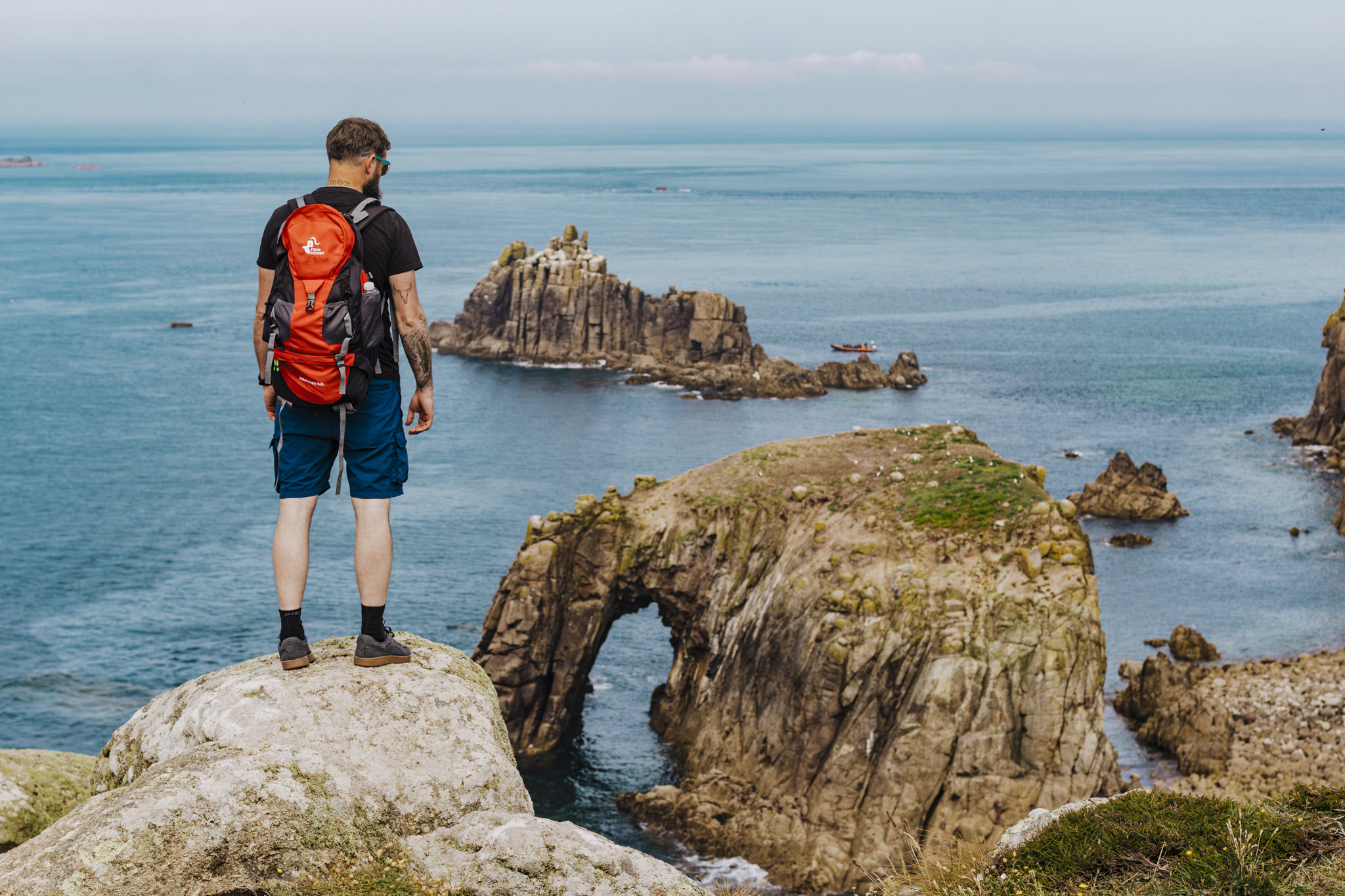 How to take good hiking photos - Man standing on a rock in Cornwall
